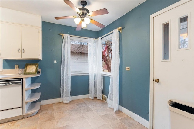 interior space with ceiling fan and baseboards