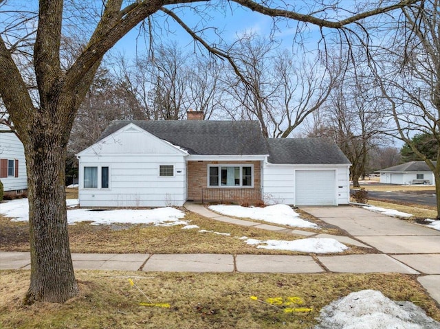 view of front of property with driveway, a shingled roof, a chimney, a garage, and brick siding