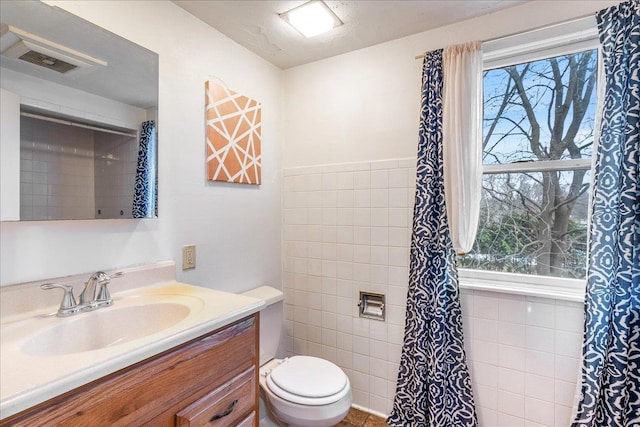 bathroom featuring visible vents, toilet, and vanity