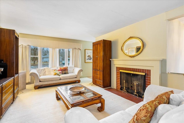 living area featuring light carpet and a brick fireplace