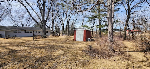 view of yard with a storage unit and an outbuilding