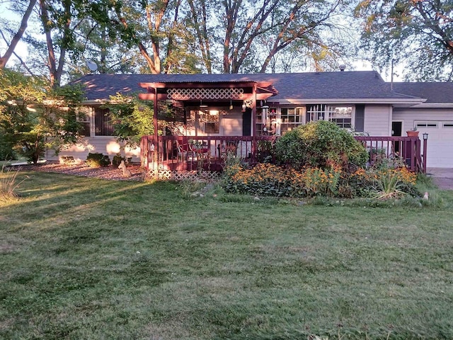 ranch-style home featuring an attached garage and a front yard