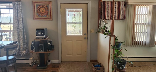 entryway featuring a baseboard heating unit, baseboards, and a baseboard radiator