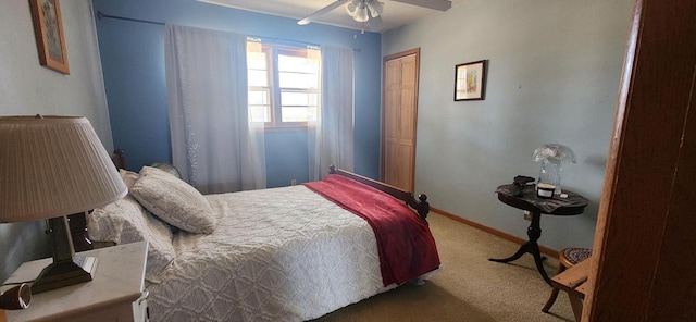 carpeted bedroom with a ceiling fan, baseboards, and a closet