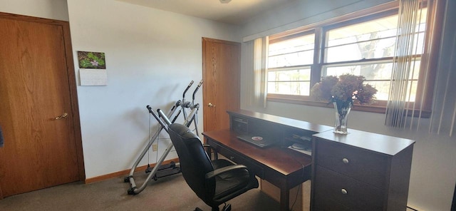 carpeted home office featuring baseboards