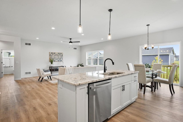 kitchen with dishwasher, light wood-type flooring, visible vents, and a sink