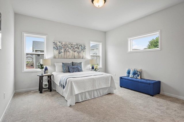 carpeted bedroom featuring baseboards