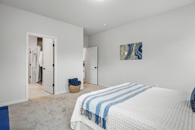 bedroom with light carpet and baseboards