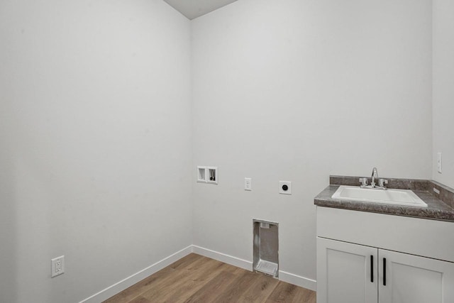 laundry area featuring light wood finished floors, baseboards, washer hookup, electric dryer hookup, and a sink