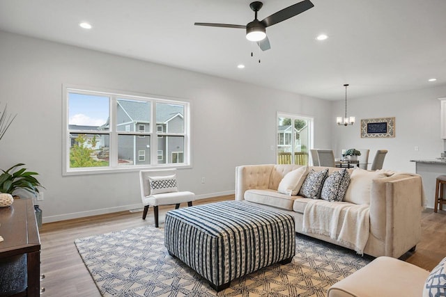 living area featuring recessed lighting, baseboards, and light wood-style floors