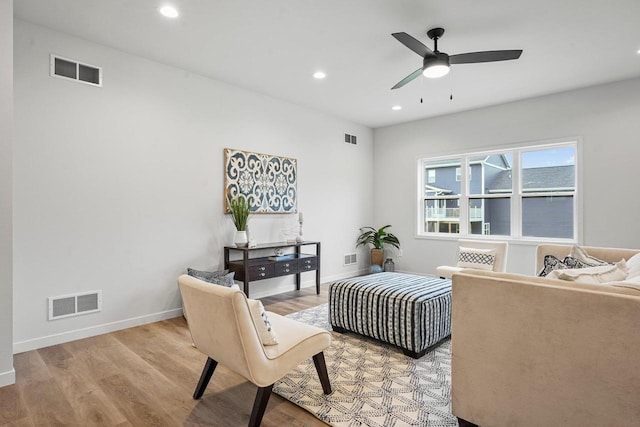 living area with baseboards, visible vents, and light wood finished floors