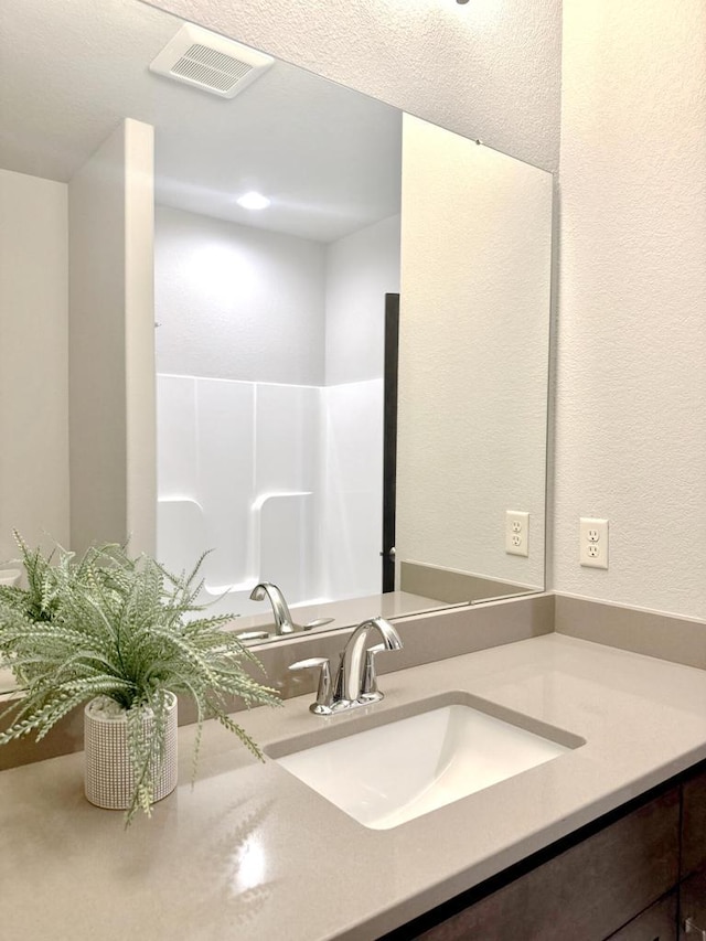 bathroom featuring visible vents and vanity