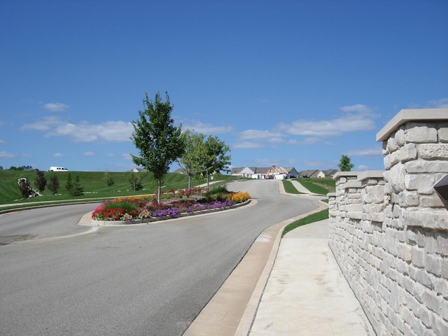 view of road featuring curbs and sidewalks