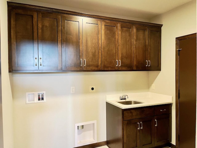 laundry room with a sink, cabinet space, hookup for an electric dryer, and hookup for a washing machine