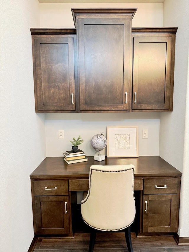 office featuring baseboards, dark wood-style flooring, and built in study area