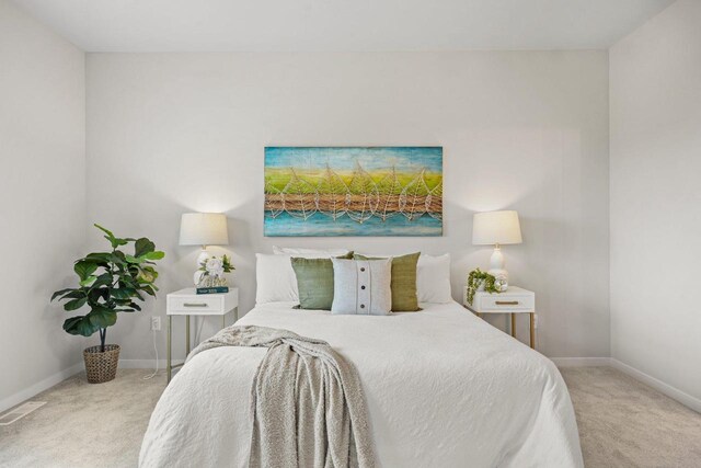carpeted bedroom featuring visible vents and baseboards