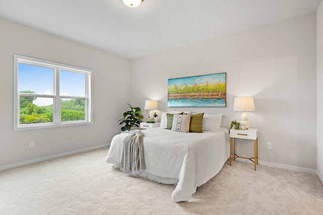 carpeted bedroom featuring baseboards