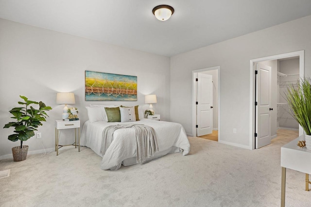 bedroom with carpet flooring, ensuite bath, and baseboards