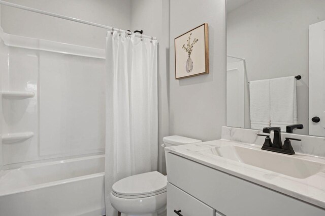 bathroom featuring shower / tub combo with curtain, toilet, and vanity
