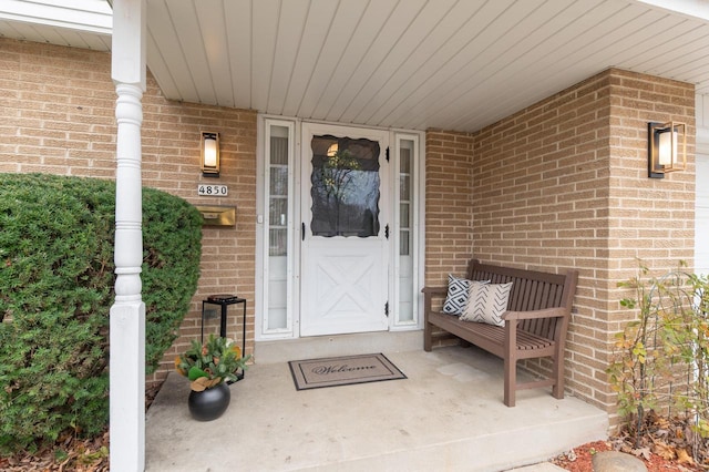 doorway to property with brick siding