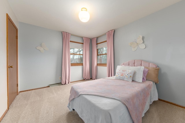 bedroom with baseboards and carpet