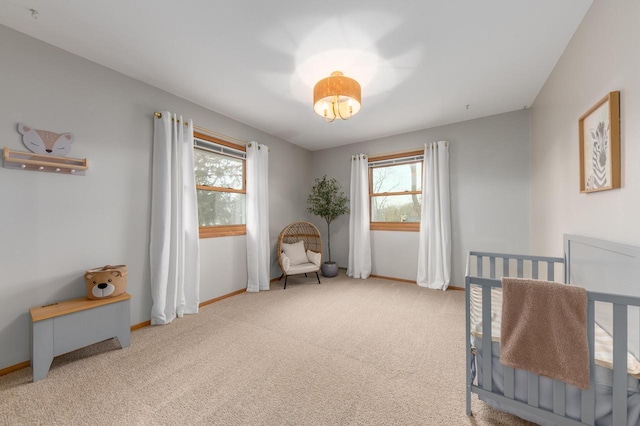 carpeted bedroom featuring baseboards