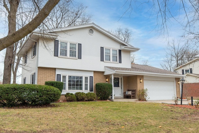 view of front facade featuring a front lawn, an attached garage, brick siding, and driveway