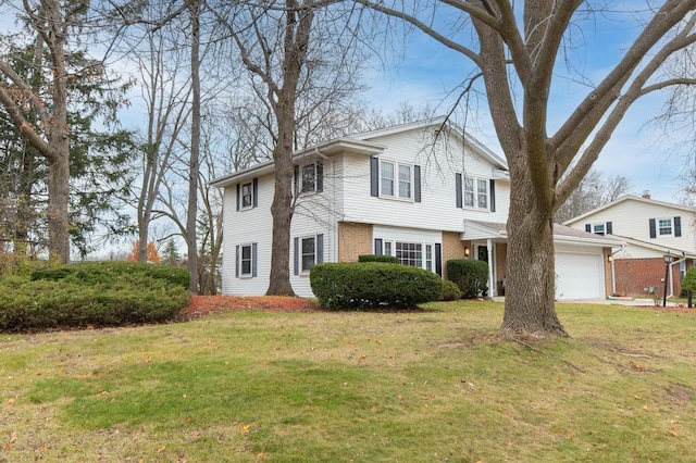 view of front facade featuring a front lawn, a garage, brick siding, and driveway