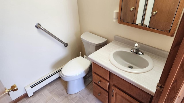 half bathroom with toilet, vanity, and a baseboard heating unit