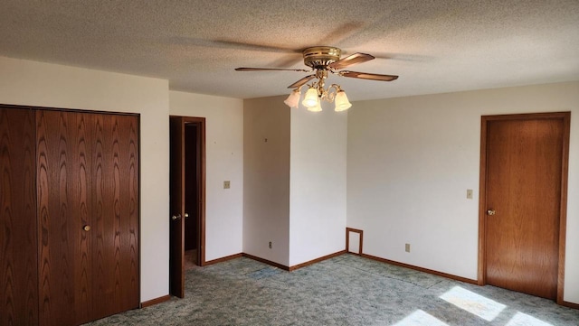 unfurnished bedroom with a ceiling fan, carpet, baseboards, a closet, and a textured ceiling