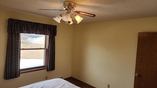 bedroom featuring a textured ceiling and ceiling fan