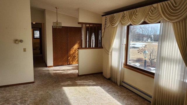 unfurnished dining area with a wealth of natural light, a baseboard heating unit, lofted ceiling, and carpet floors