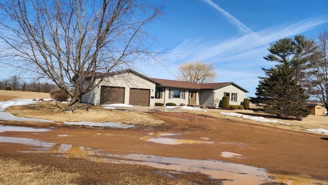 view of front of property with driveway and a garage