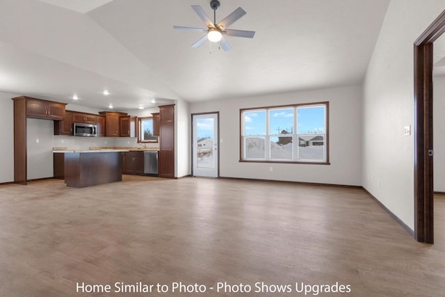 unfurnished living room with high vaulted ceiling, baseboards, light wood-type flooring, and ceiling fan