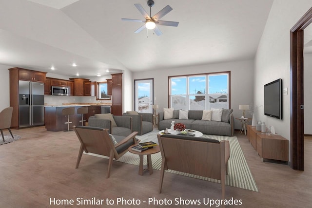 living area with light wood-style flooring, high vaulted ceiling, and ceiling fan