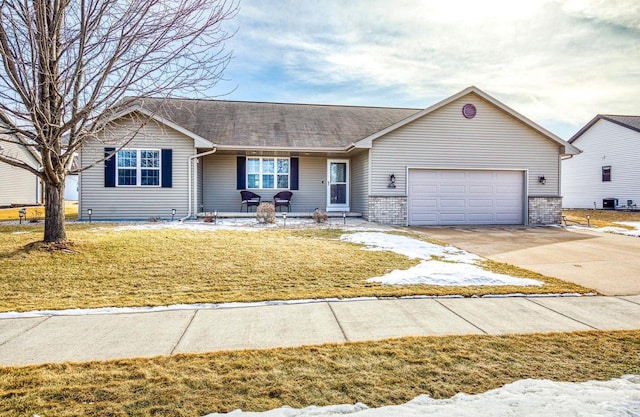 ranch-style home with covered porch, an attached garage, concrete driveway, and a front lawn