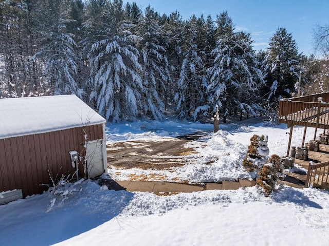 snowy yard featuring a garage