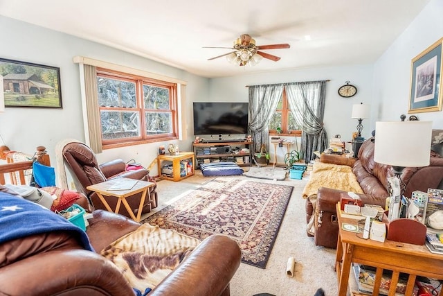 living area with carpet and ceiling fan