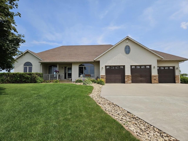 view of front of house with a porch, a front yard, a garage, and concrete driveway