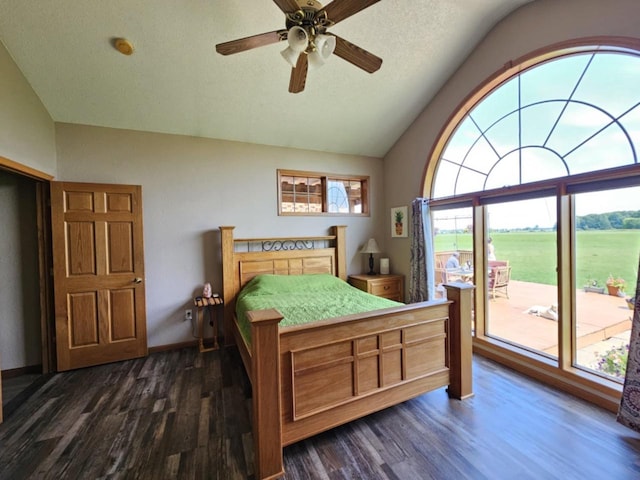 bedroom featuring a textured ceiling, dark wood-style flooring, vaulted ceiling, and access to outside