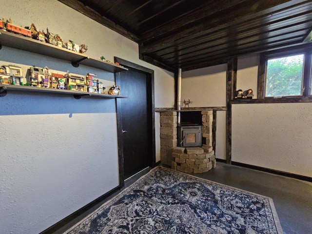 hall featuring baseboards and a textured wall