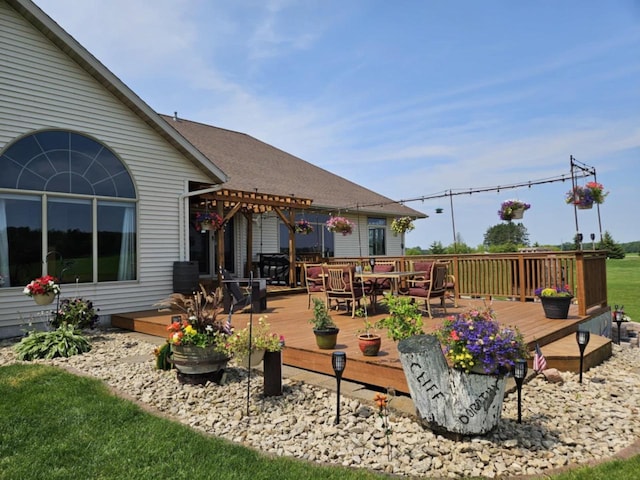 wooden deck with outdoor dining space and a pergola