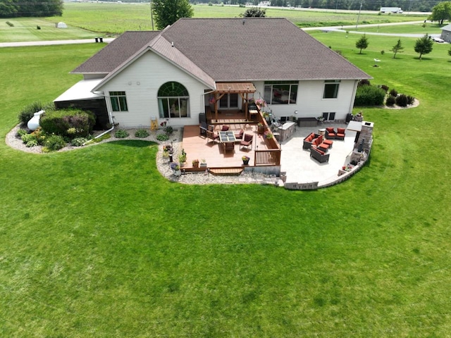 rear view of property with a lawn, outdoor lounge area, a deck, and roof with shingles