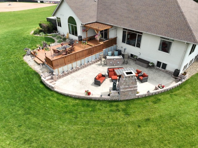 back of property with a shingled roof, outdoor dining area, a yard, and a wooden deck