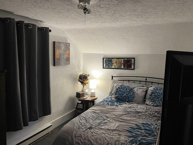 bedroom with baseboard heating, a textured ceiling, baseboards, and a textured wall