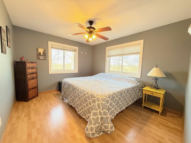 bedroom with light wood-style floors and ceiling fan