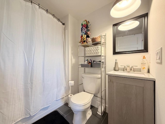 full bathroom featuring tile patterned flooring, shower / bath combination with curtain, toilet, and vanity