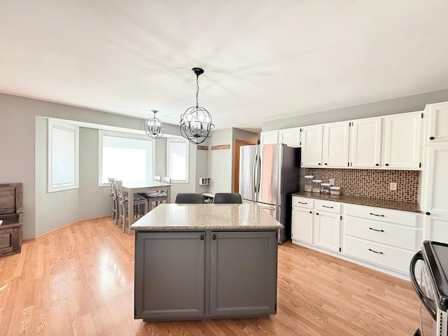 kitchen featuring a kitchen island, white cabinetry, and stainless steel appliances