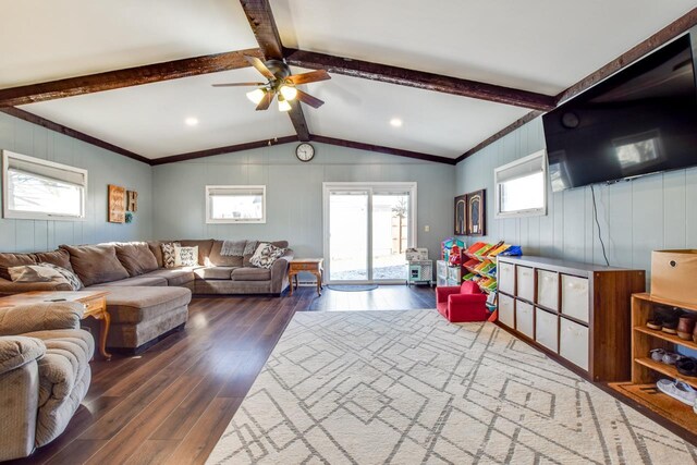 living area with vaulted ceiling with beams, a ceiling fan, and hardwood / wood-style floors