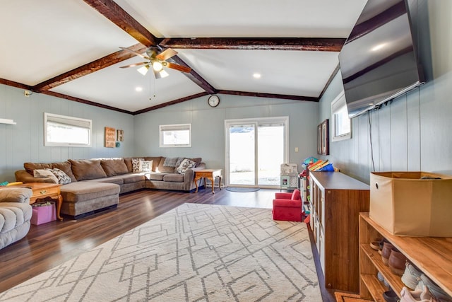 living room featuring vaulted ceiling with beams, ceiling fan, and wood finished floors